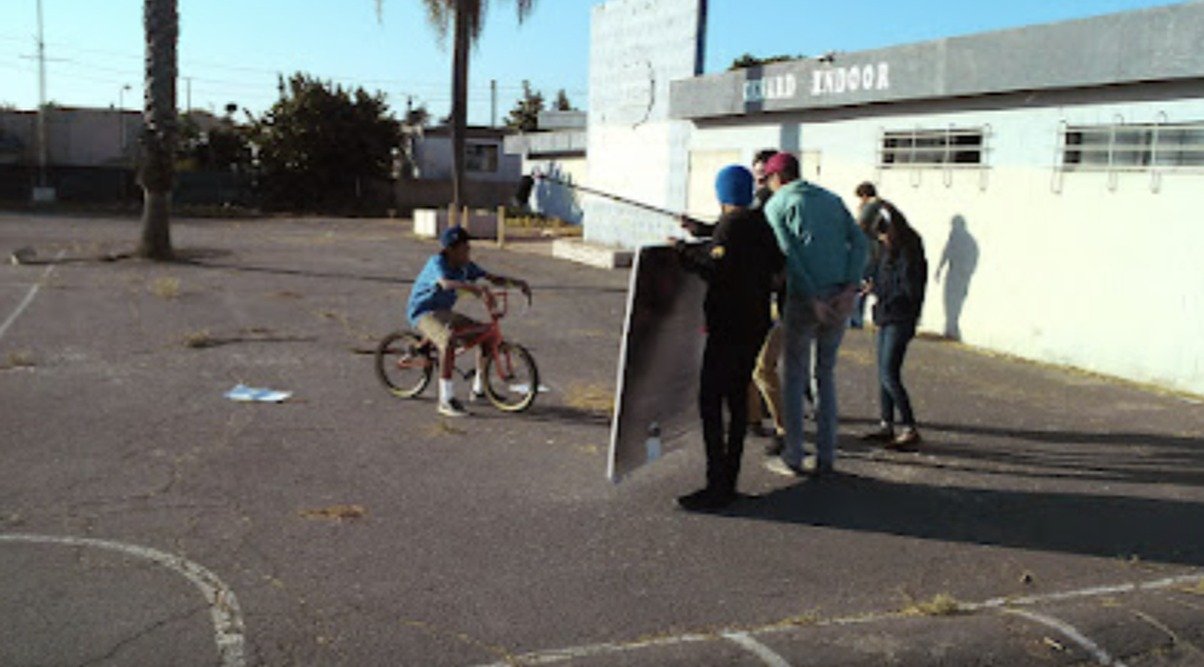 Archival outdoor film production with a bicycle and crew