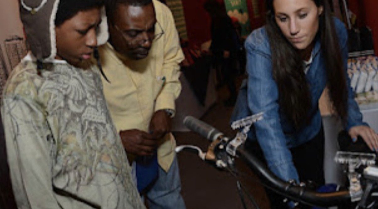 A young performer and adults reviewing camera equipment together